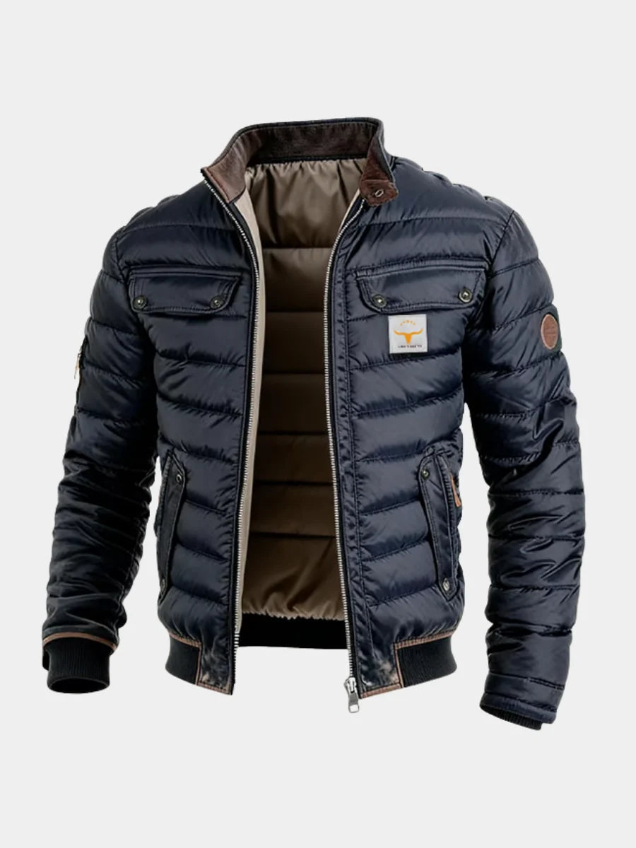 Men's quilted puffer jacket in navy with high collar and chest pockets on grey background