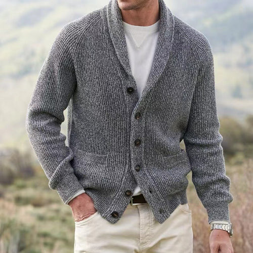 Men's ribbed knit cardigan in grey with shawl collar and button-front closure worn casually outdoors