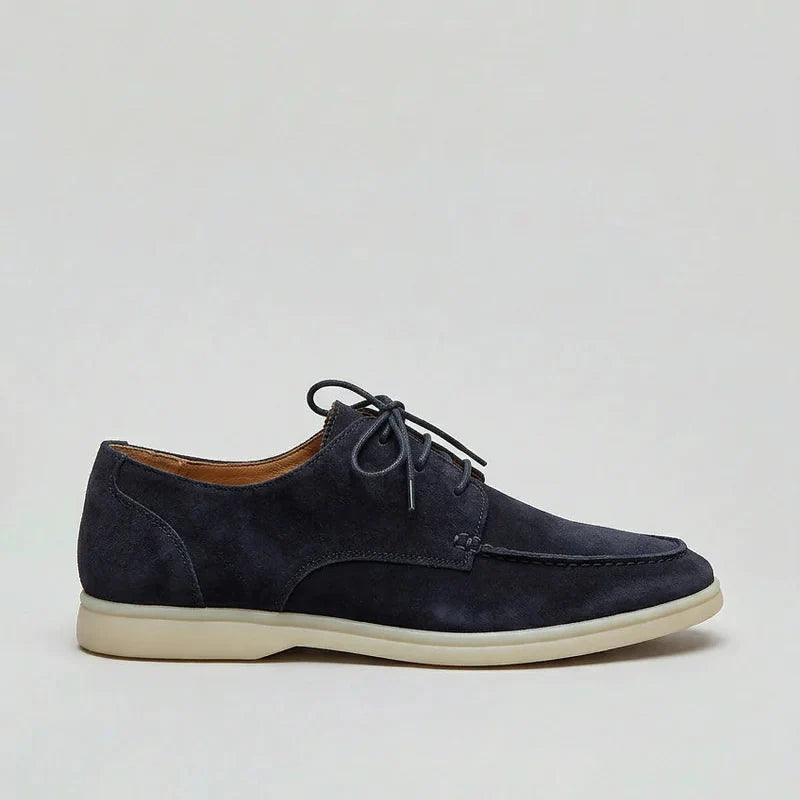 Side profile of men's navy loafers with lightweight sole and structured suede-effect upper