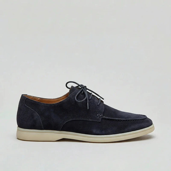 Side profile of men's navy loafers with lightweight sole and structured suede-effect upper