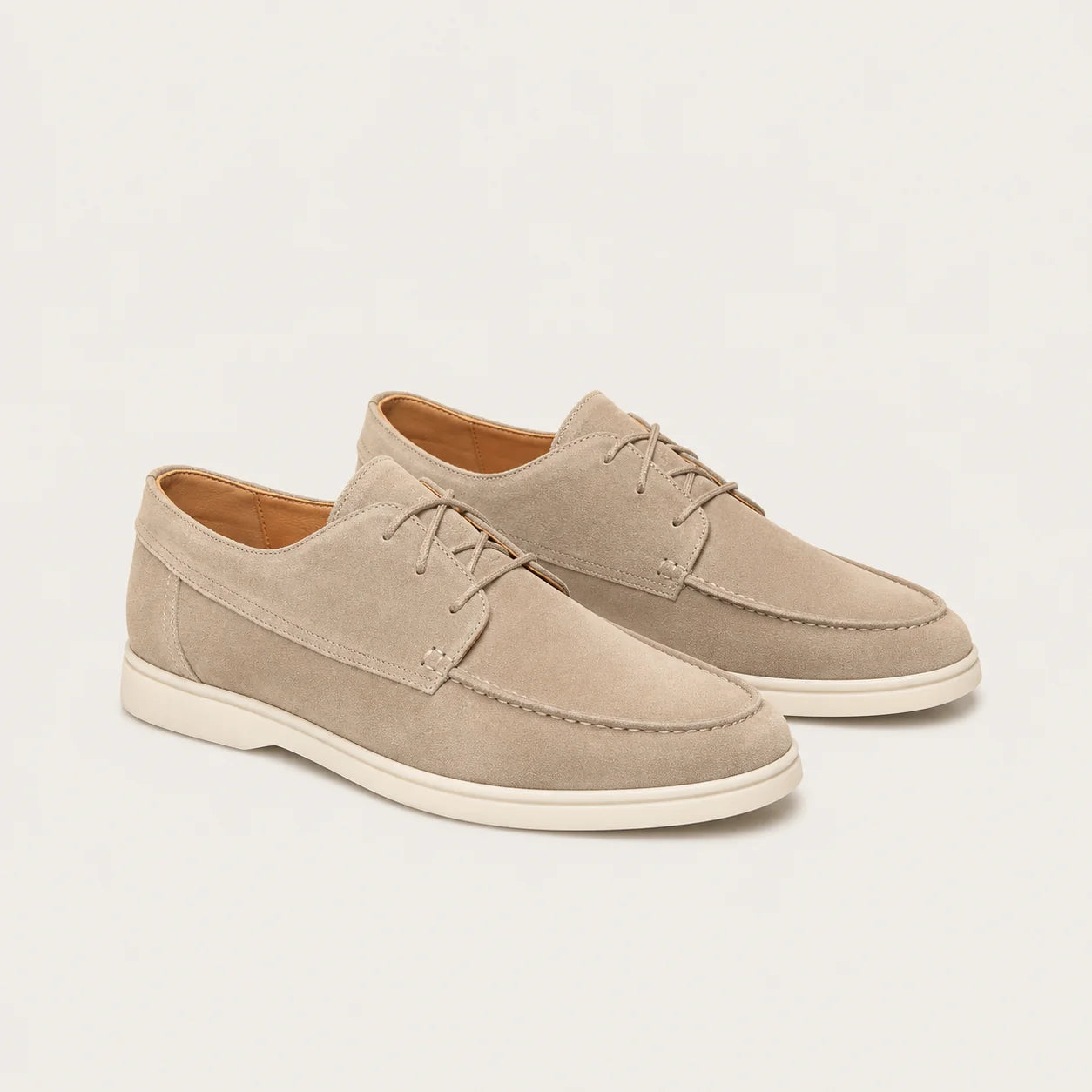 Detail shot of men's loafers showing soft suede-effect fabric and refined stitching finish