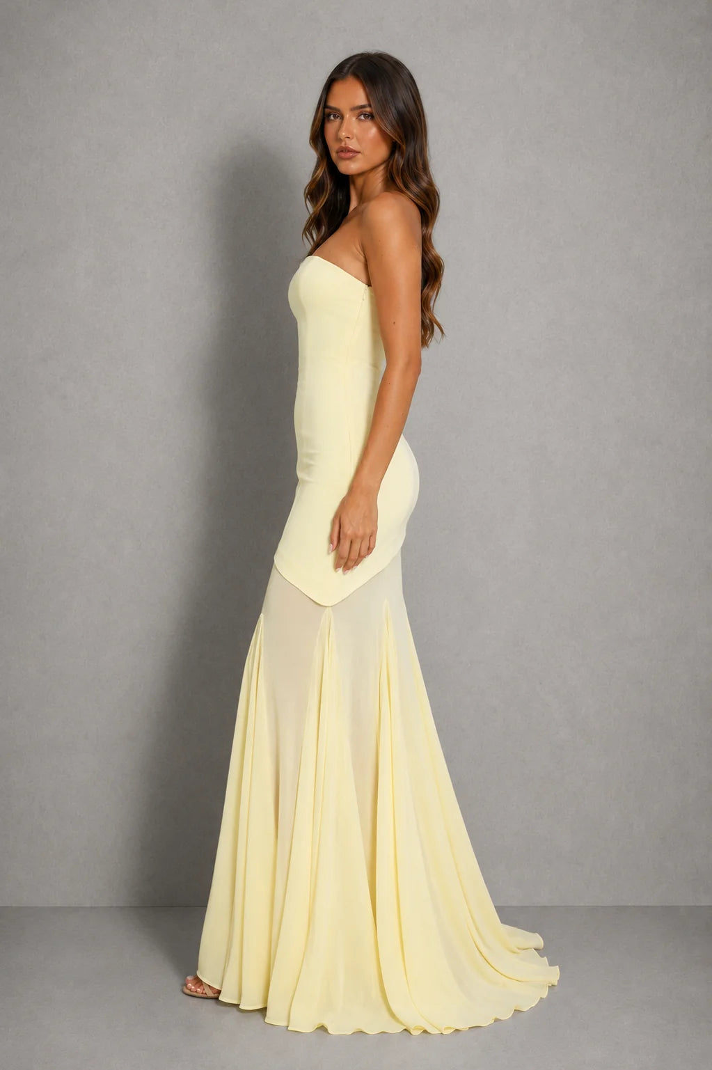 Side view showing asymmetric sheer overlay and flowing skirt detail