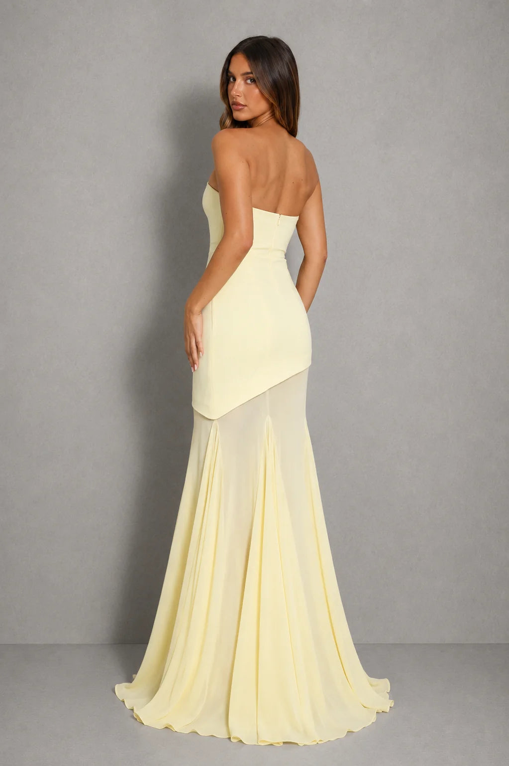 Full-length view of strapless maxi dress with floor-length sheer layer