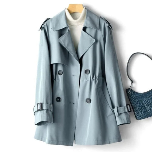 Close-up view of double-breasted button closure and wide notched lapels on sage trench coat