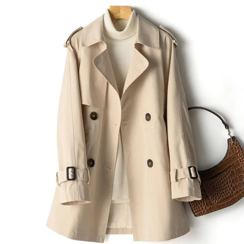 Side profile of mid-length trench coat showing structured silhouette and shoulder epaulet detail
