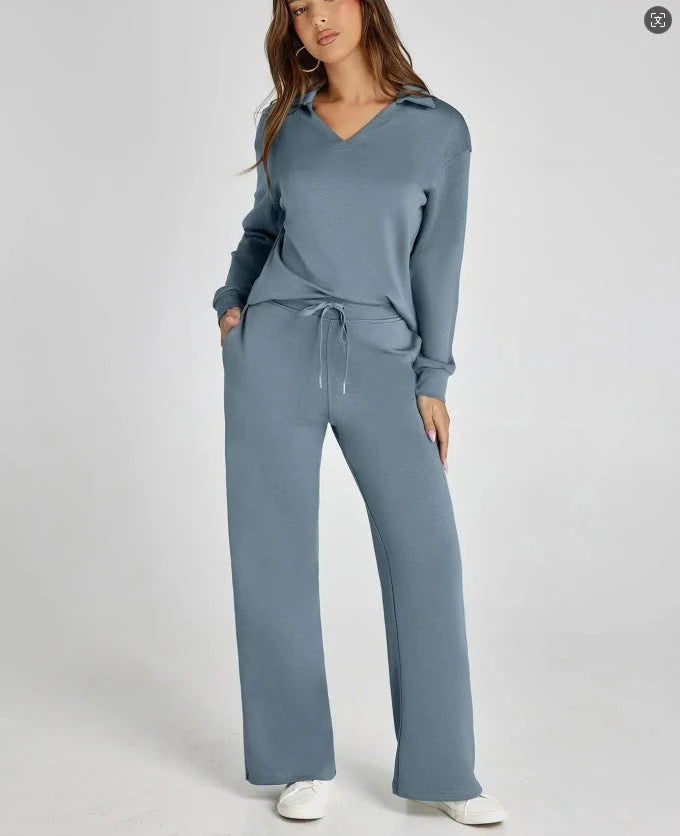 Women's two-piece lounge set in black with V-neck top and flowing wide-leg trousers for everyday comfort