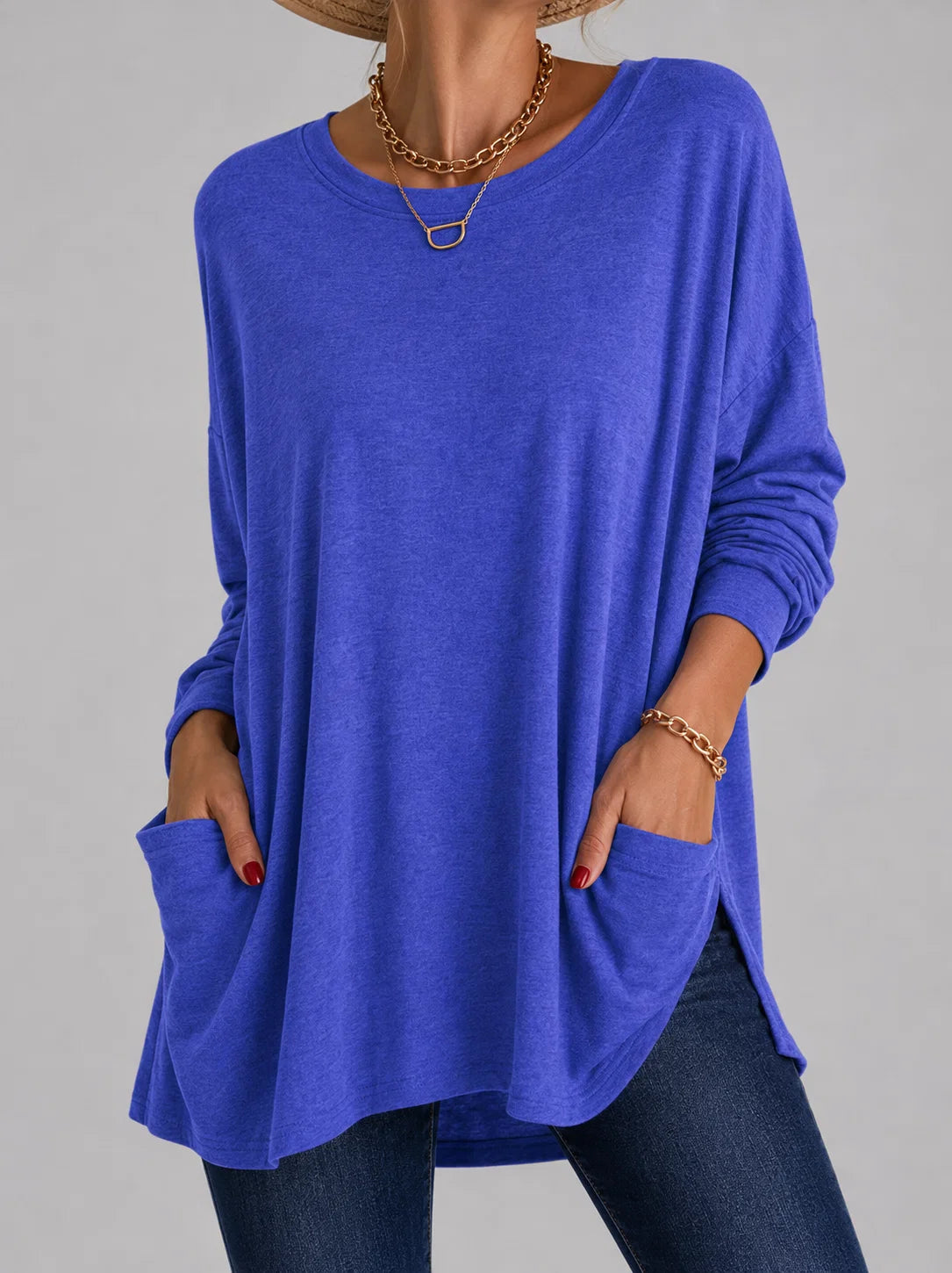Women's grey tunic top with pockets showing soft fabric drape and relaxed casual fit
