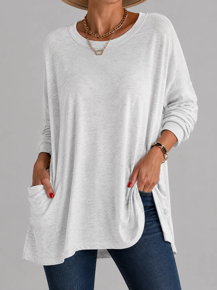 Women's pink tunic top with oversized fit and round neckline paired with casual styling