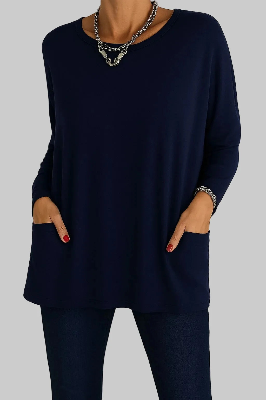 Front view of women's oversized tunic top showing flowing silhouette and two front pockets with round neckline