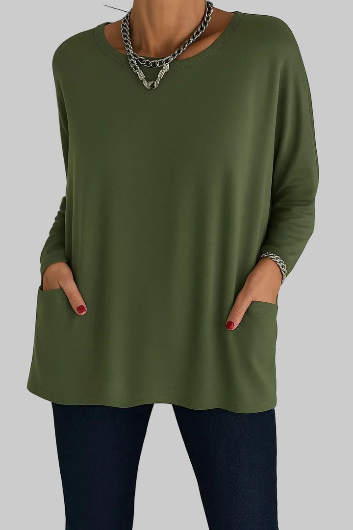 Close-up detail of women's tunic top front pockets and soft fabric with gentle stretch