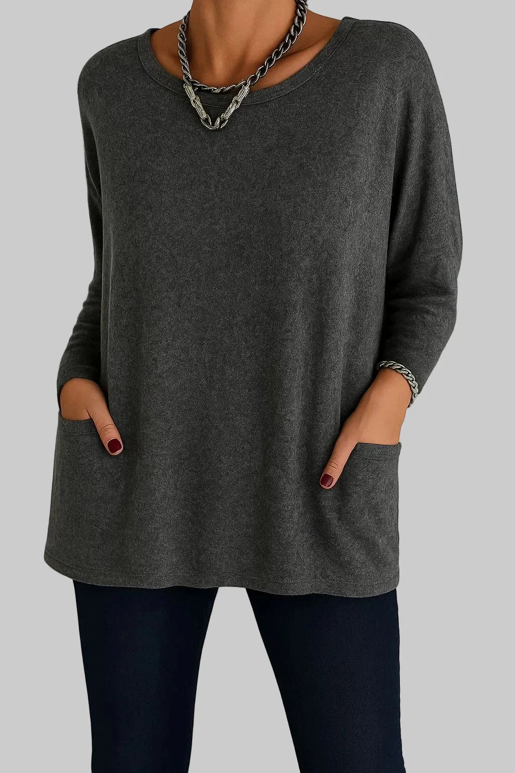 Back view of women's black tunic top with oversized flowing shape and round neckline