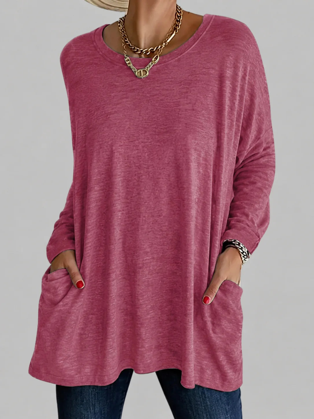 Women's tunic top in navy blue showing relaxed fit and front pocket detail with long sleeves