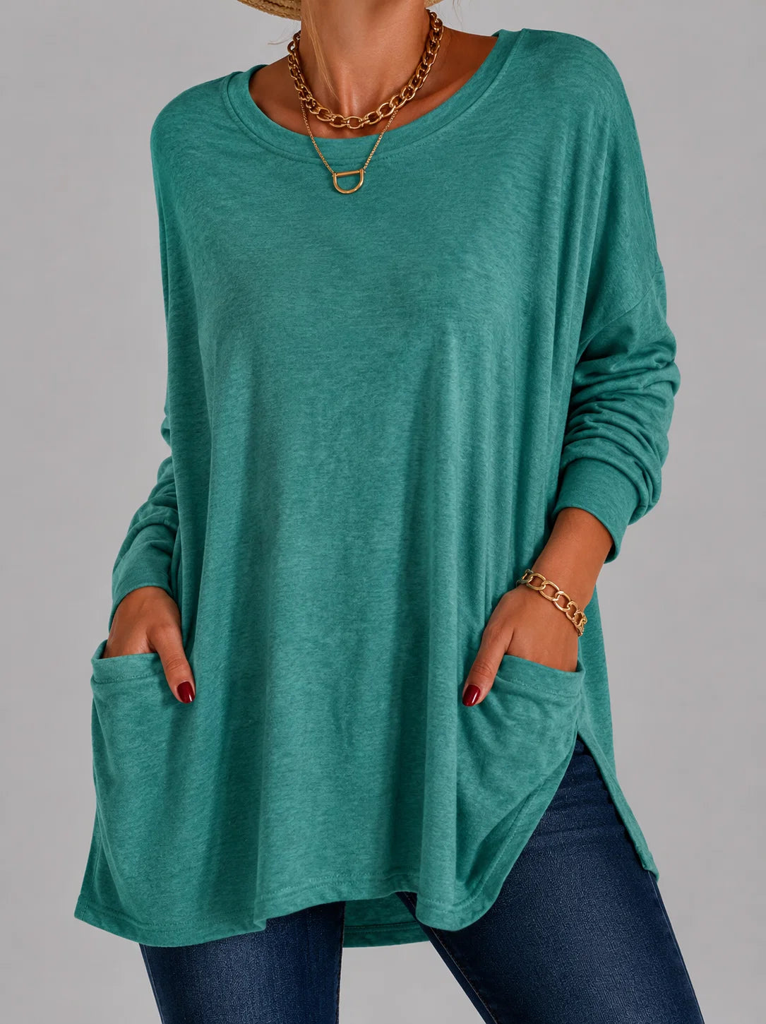 Women's tunic top in green displaying long tunic length and comfortable oversized silhouette
