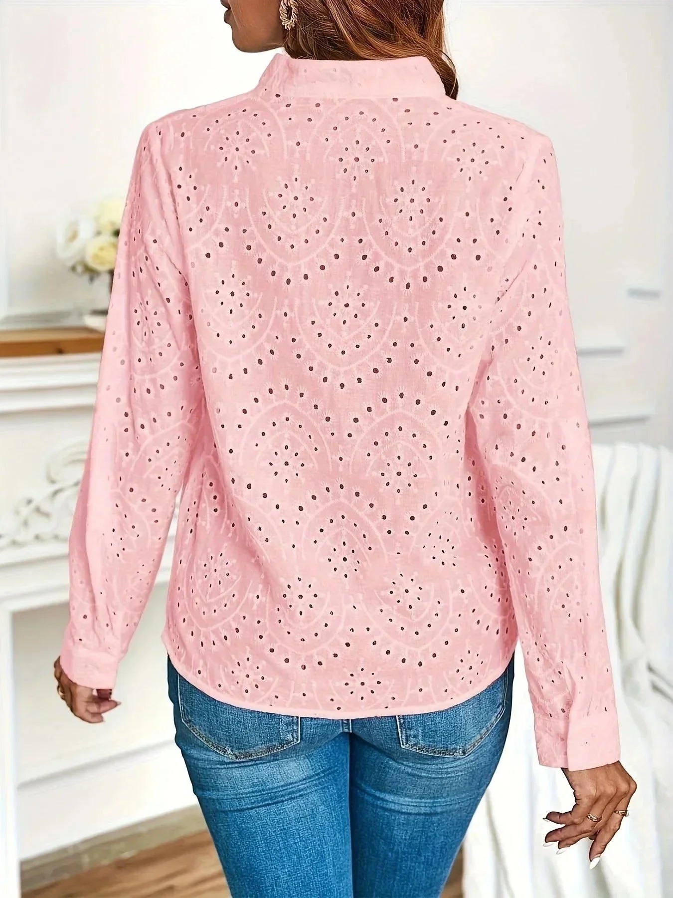 Women's V-neck blouse in white showing textured fabric finish and casual fit
