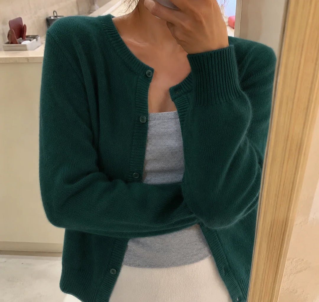Women's cropped knit cardigan in grey showing round neckline and hip-length cut
