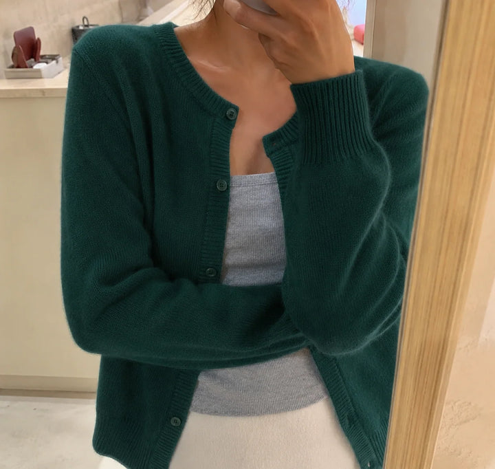 Women's cropped knit cardigan in grey showing round neckline and hip-length cut