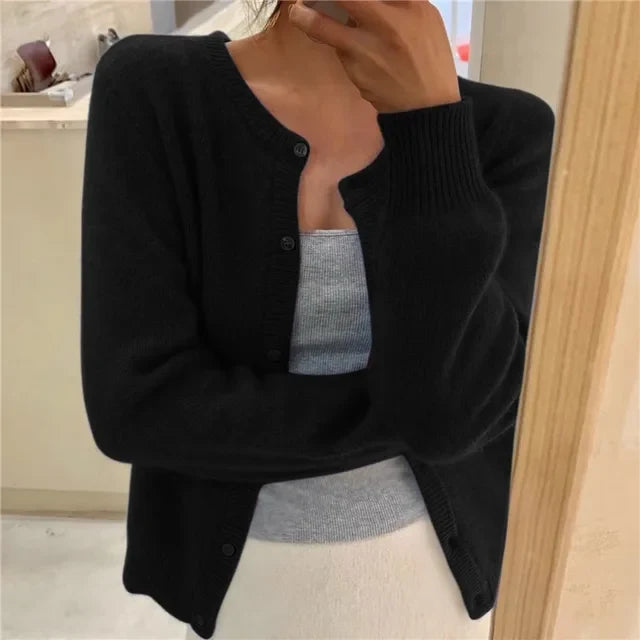 Close-up of soft brushed knit fabric and button placket detail on women's cropped cardigan