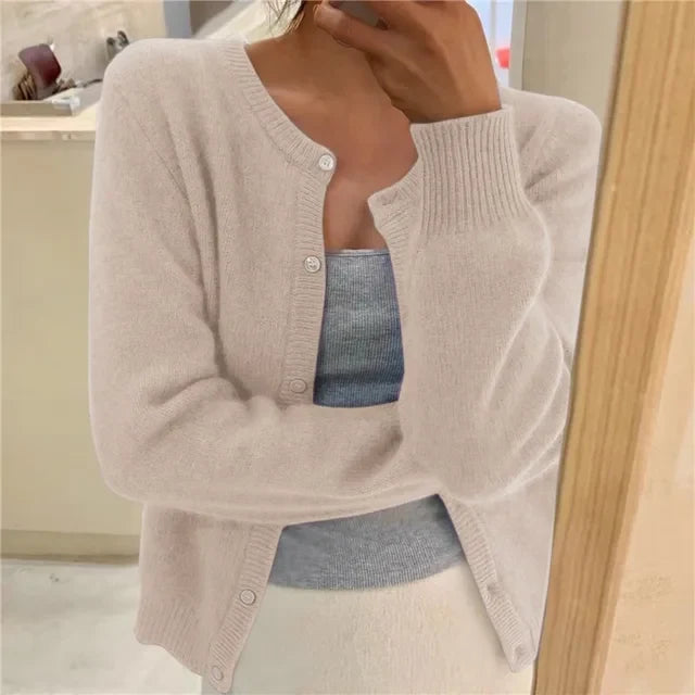 Side view of relaxed fit cropped cardigan showing hip-length hem and ribbed cuffs
