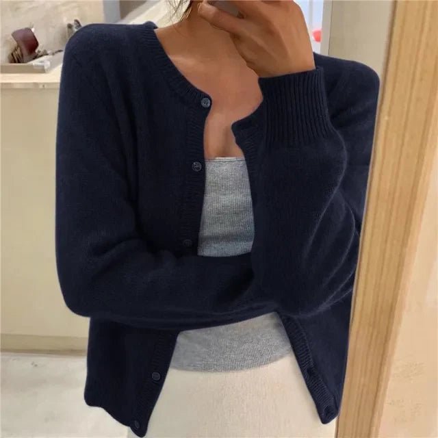 Women's grey cardigan layered over camisole demonstrating versatile styling options