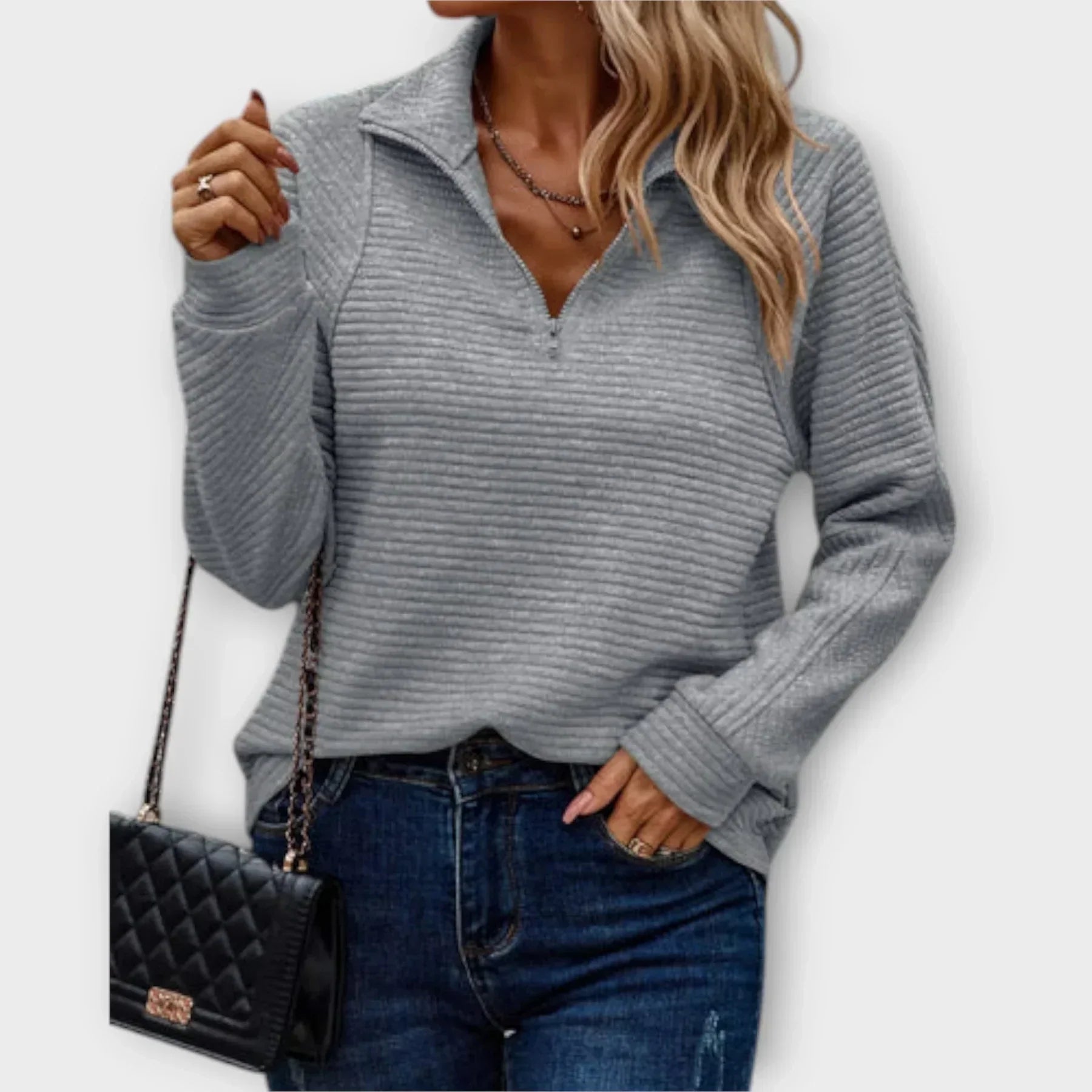 Side view showing relaxed fit and ribbed cuffs on women's quarter-zip jumper