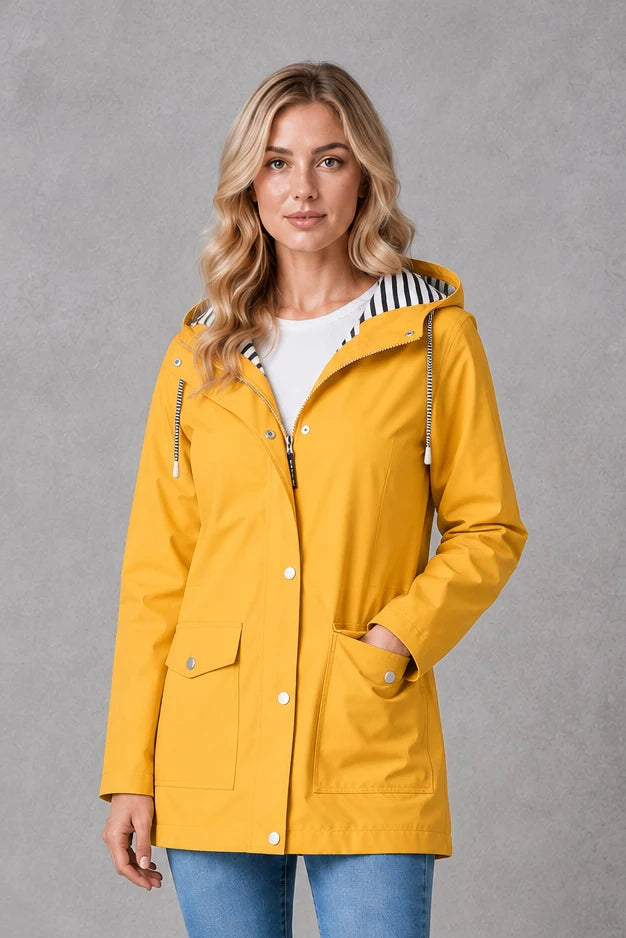 Women's hooded raincoat in yellow with snap-button front closure and adjustable hood worn over white tee
