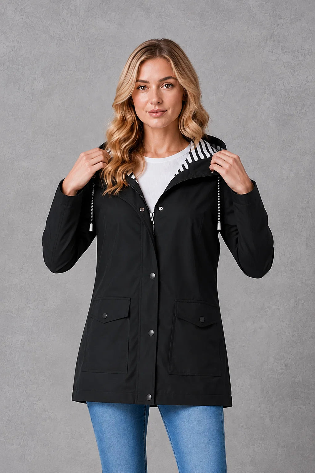 Hooded waterproof jacket for women in yellow with snap closures and mid-thigh coverage
