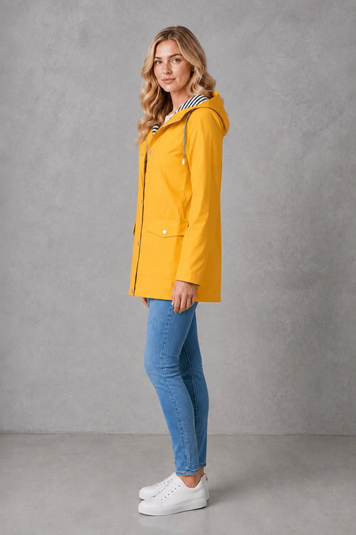 Yellow hooded raincoat for women featuring patch pockets and mid-thigh length with water-resistant finish