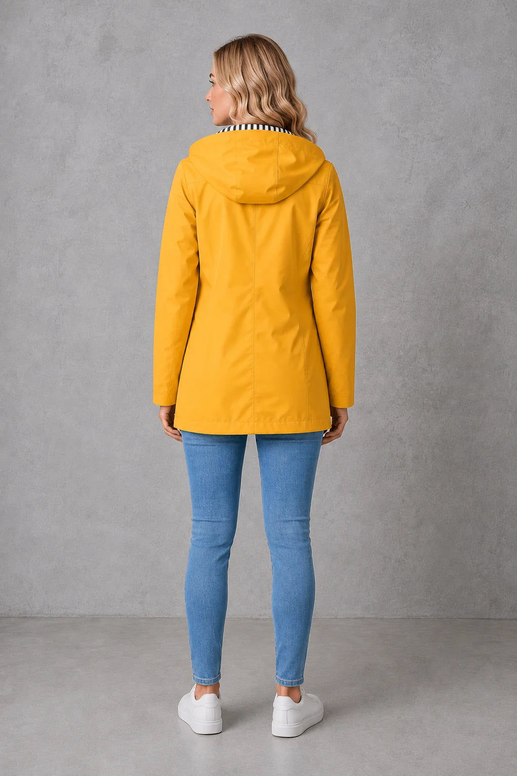 Women's raincoat with striped hood lining and relaxed fit silhouette for layering over jumpers