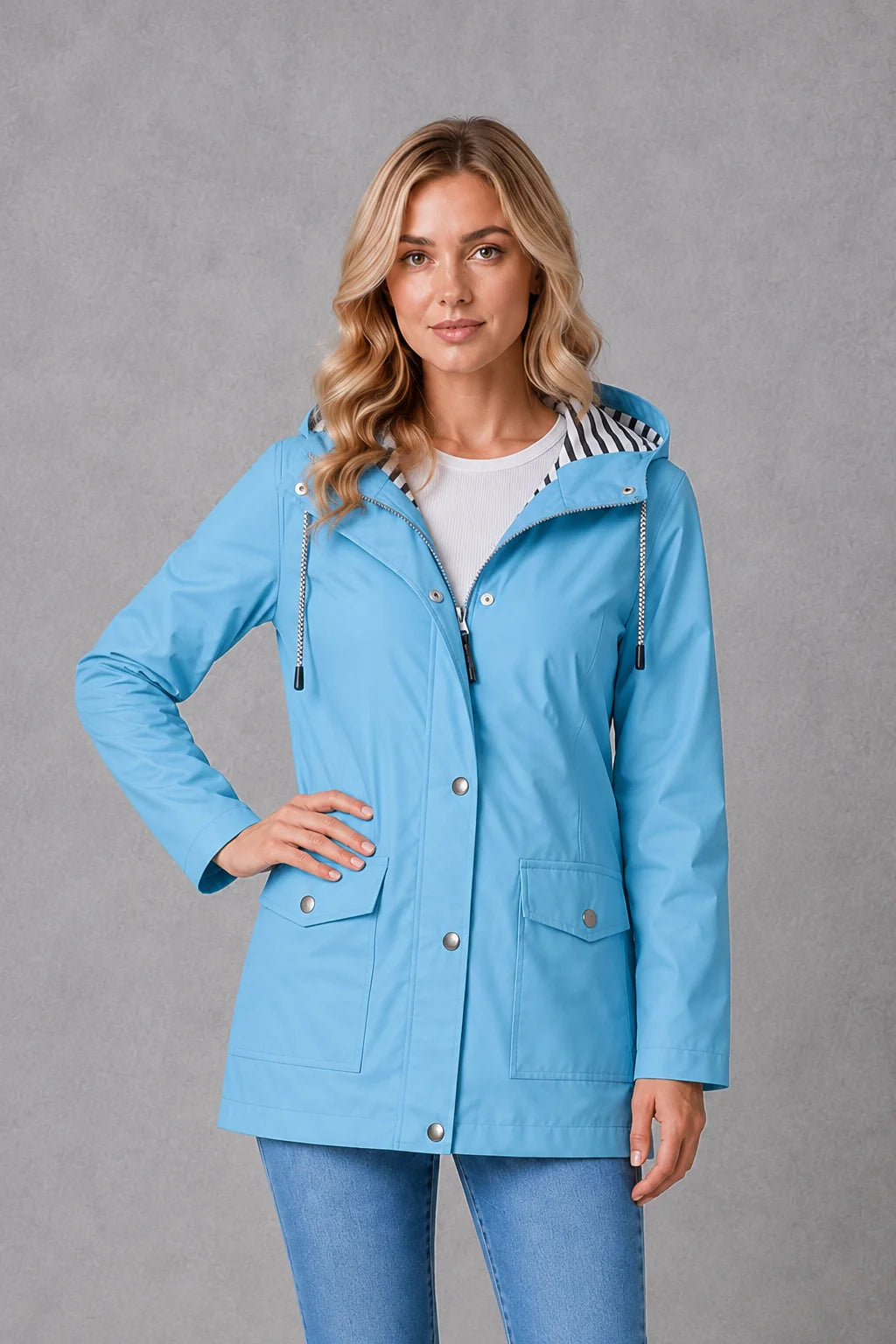 Women's raincoat featuring snap-button front and contrast striped lining inside adjustable hood