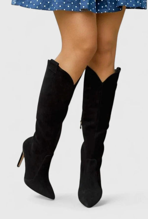 Side view of knee-high heeled boots showing sleek silhouette and side zip closure detail