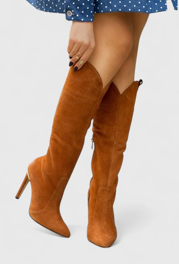 Detail of side zip fastening and structured finish on women's knee-high heeled boots
