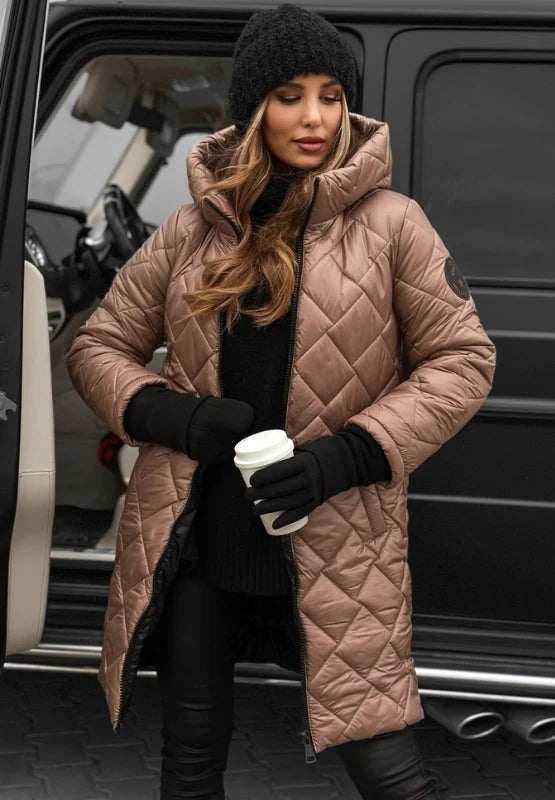Woman wearing beige quilted puffer coat with diamond stitching and attached hood, longline silhouette