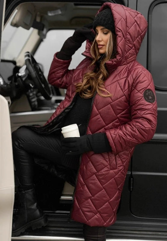 Full-length view of women's longline quilted puffer coat with hood and zip front