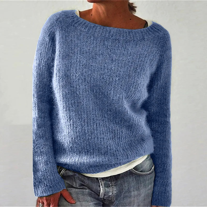 Close-up of textured knit fabric and boat neck detail on women's relaxed jumper