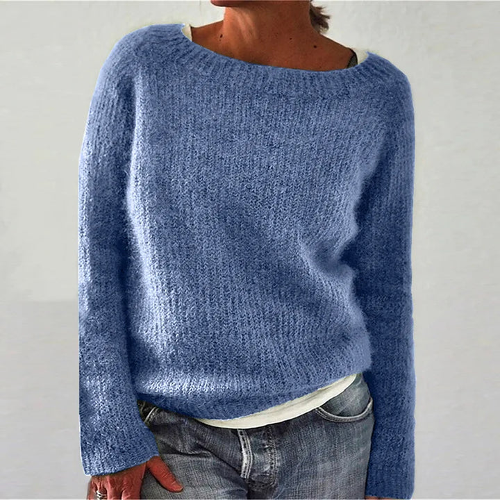 Close-up of textured knit fabric and boat neck detail on women's relaxed jumper