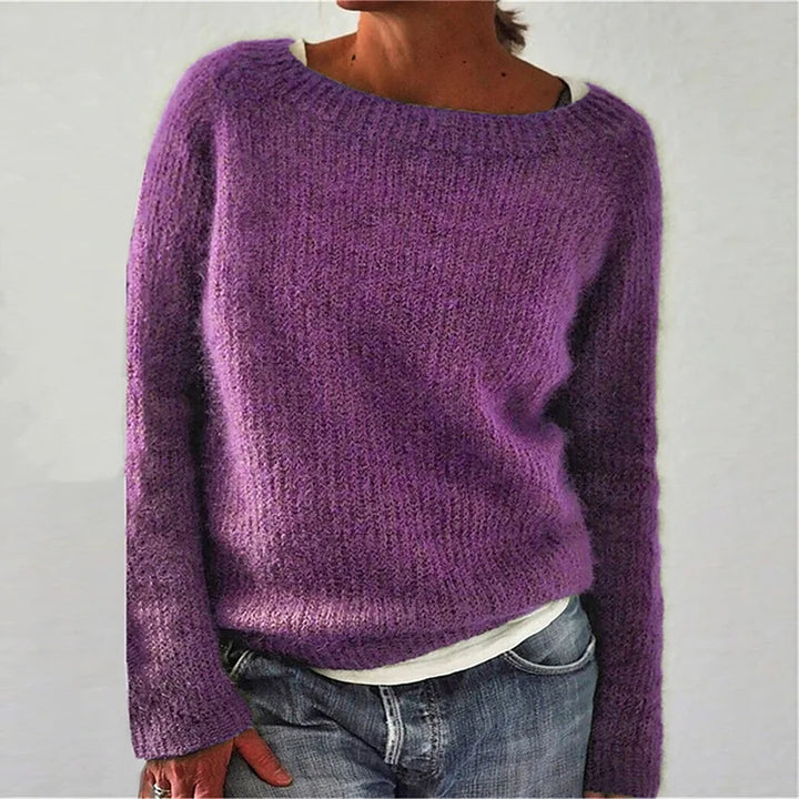 Side view of women's loose knit jumper showing relaxed drape and ribbed hem