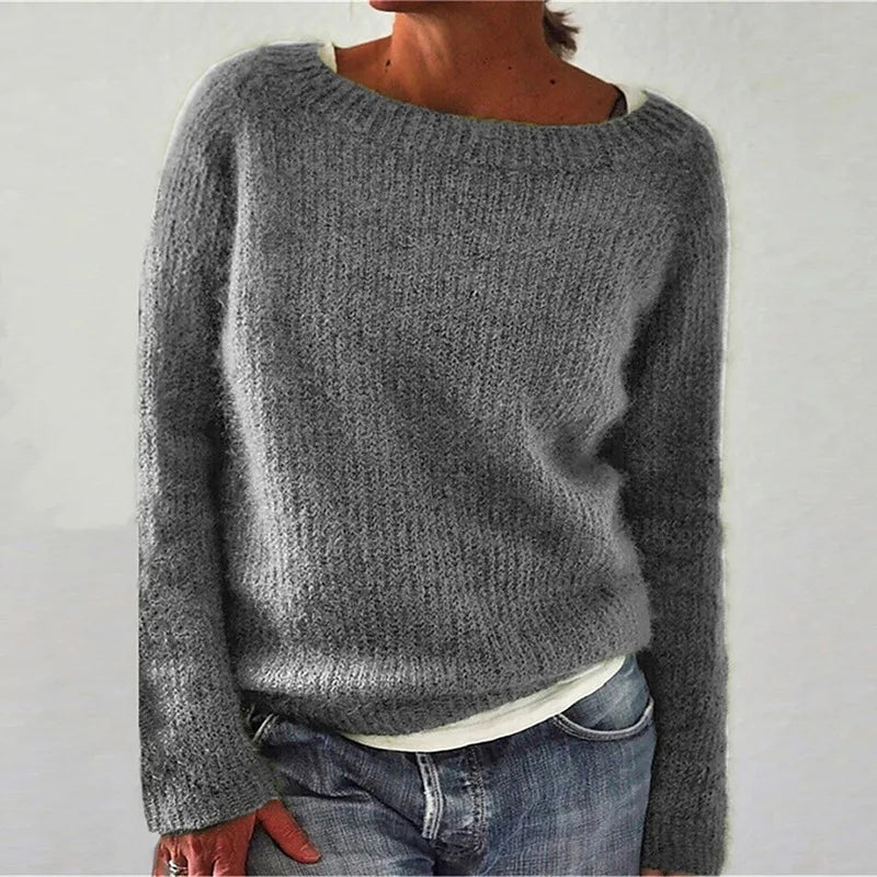 Detail of soft textured knit and long sleeves on women's relaxed jumper