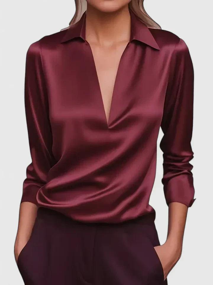 Close-up view of women's white satin blouse showing smooth fabric finish and collar detail