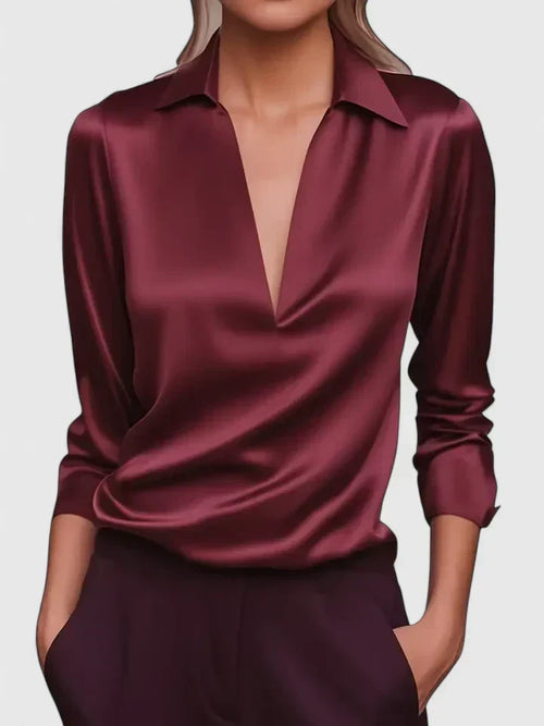 Close-up view of women's white satin blouse showing smooth fabric finish and collar detail