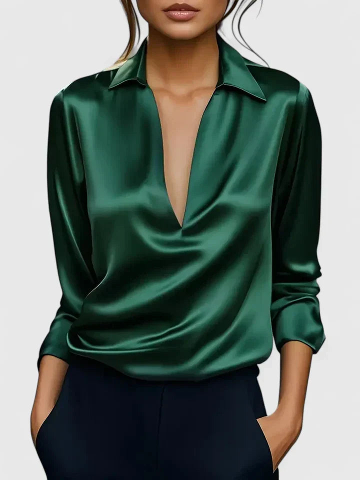 Side view of women's satin blouse showing fluid drape and long sleeve with cuff