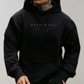 Men's oversized hoodie in black with minimalist chest print and kangaroo pocket detail