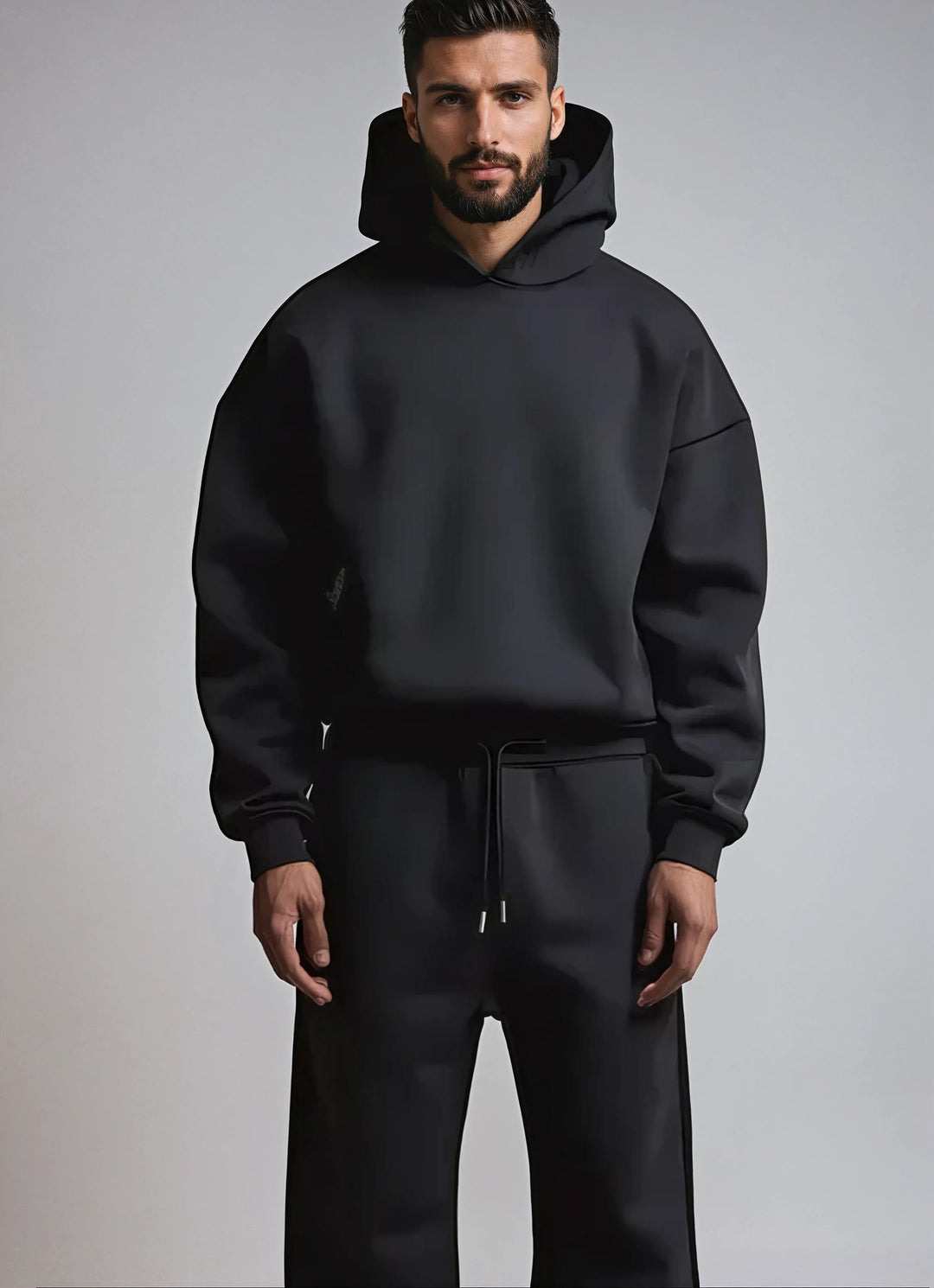 Oversized men's hoodie and joggers set styled with white trainers for casual wear