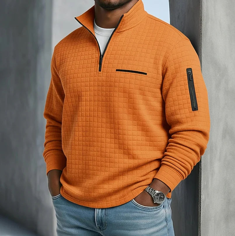 Men's quilted half-zip sweatshirt in orange with textured grid pattern and contrast zip detail
