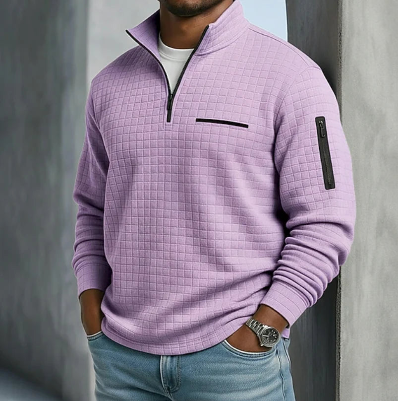 Side angle of men's orange quilted sweatshirt with sleeve zip pocket and ribbed cuffs