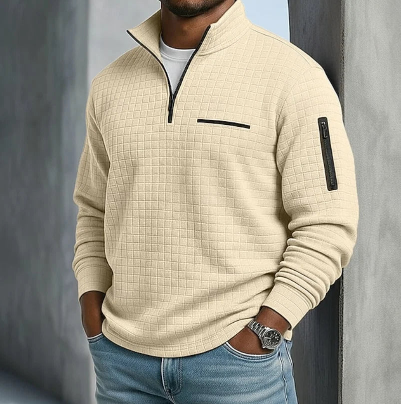 Detail shot of quilted grid texture and contrast zip trim on men's sweatshirt