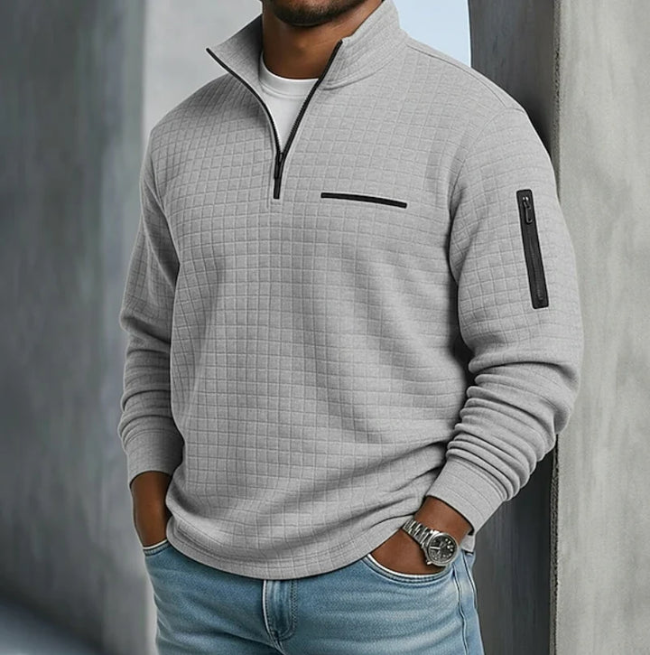 Men's half-zip sweatshirt in orange showing relaxed fit and ribbed hem construction