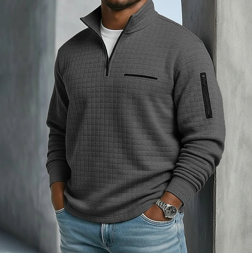 Full-length view of men's quilted sweatshirt paired with casual trousers