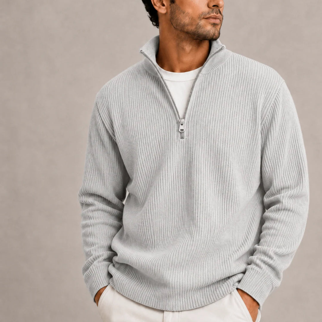 Close-up of ribbed cuffs and hem detail on men's quarter-zip jumper
