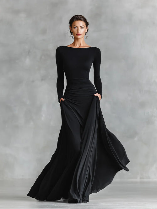 Model wearing black ruched maxi dress with boat neckline and long sleeves for formal occasions