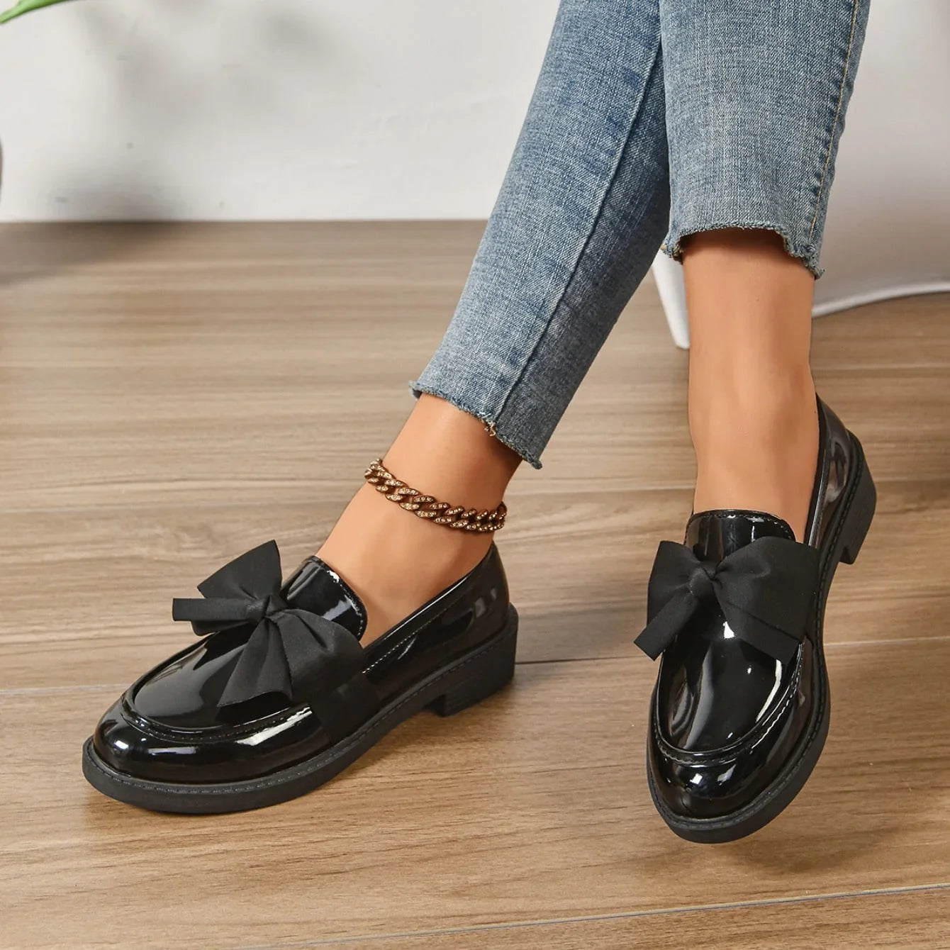 Overhead view of glossy bow detail loafers showing rounded toe shape